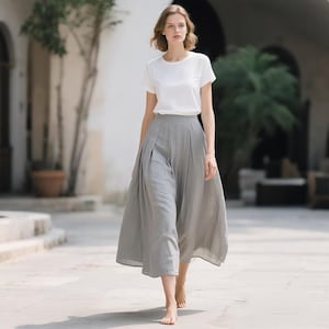 Saia midi de linho feminina, com frente lisa, elástico nas costas, cintura alta, pregas, corte em A, com bolsos, sob medida.