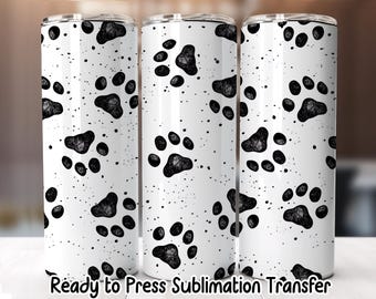 May include: Three white stainless steel tumblers with a black paw print pattern and black speckles. The text "Ready to Press Sublimation Transfer" is at the bottom of the tumblers. The tumblers have a silver lid.
