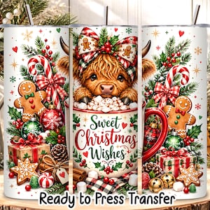 May include: A cylindrical tumbler wrap featuring a fluffy highland cow peeking out of a mug filled with marshmallows. The design includes gingerbread cookies, candy canes, pine branches, red bows, gift boxes, and the text Sweet Christmas Wishes.