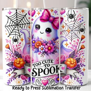 May include: White tumbler with a Halloween-themed design. It features a cute ghost with a pink bow, surrounded by flowers, pumpkins, and spiderwebs. The text "Too Cute to Spook" is displayed on a banner.