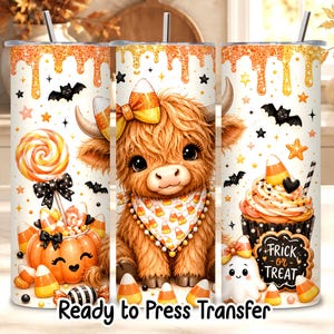 May include: A cylindrical tumbler featuring a Halloween theme with a fluffy highland cow wearing a candy corn bow and bandana, surrounded by pumpkins, cupcakes, bats, stars, and candy corn. The text "FRICK or TREAT" is printed on a cookie.