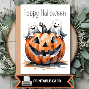May include: A Halloween greeting card with a watercolor illustration. The card features a smiling jack-o'-lantern with two friendly ghosts and the text "Happy Halloween". The bottom of the card reads "PRINTABLE CARD".