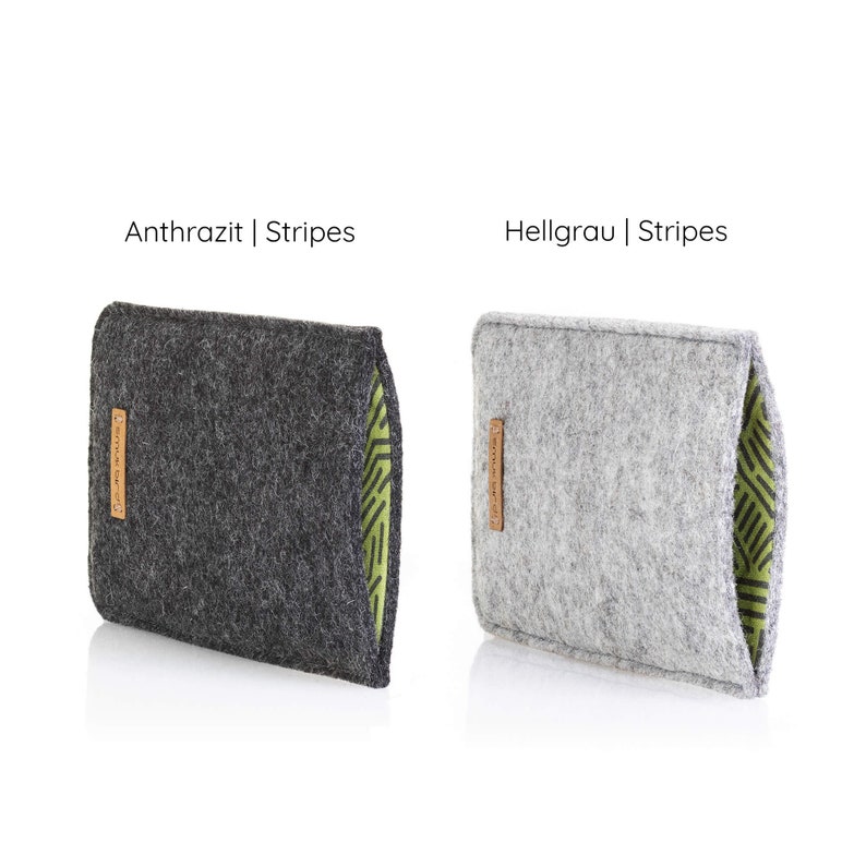 May include: Two felt pouches with a green and white striped lining. The pouch on the left is dark gray and says "Anthrazit | Stripes". The pouch on the right is light gray and says "Hellgrau | Stripes".