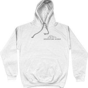 May include: White hoodie with a drawstring hood and a front pocket. The hoodie features a small mountain graphic and the text "ADVENTURE JUNKIE" in black. A casual, comfortable garment for outdoor enthusiasts.