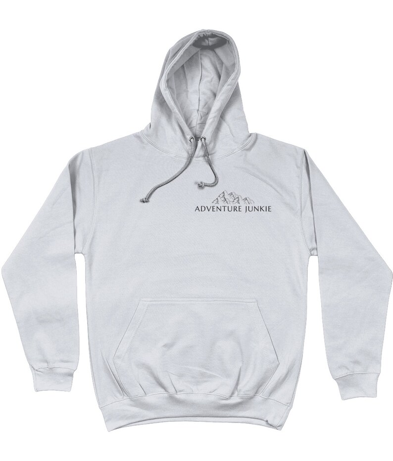 May include: A light gray hoodie with a drawstring hood and a front pocket. The hoodie features a small mountain graphic and the text "ADVENTURE JUNKIE" printed in dark gray. The hoodie is made of a soft material.