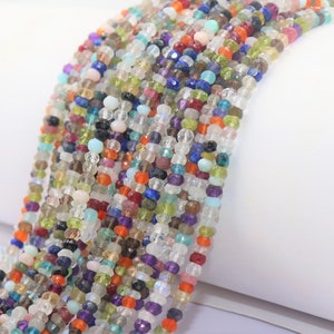 May include: A strand of colorful gemstone beads, featuring a variety of shapes and sizes. The beads are strung on a clear thread and are ready to be used for jewelry making.