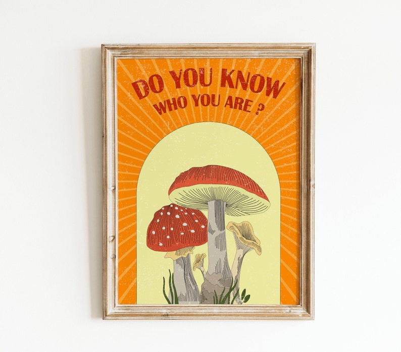 May include: Framed art print featuring a vintage-style illustration of mushrooms. The artwork includes the text "DO YOU KNOW WHO YOU ARE?" in orange, set against a yellow and orange background. The mushrooms are red and white, with gray stems.