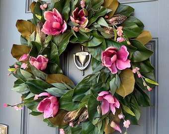 Magnolia wreath for front door with realistic pink magnolia blooms nestled in green magnolia leaves with pods, ferns,blossoms all handmade.