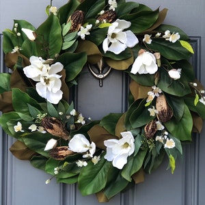 Magnolia wreath for front door with realistic white magnolia blooms nestled in green magnolia leaves with pods, ferns,blossoms all handmade. image 1