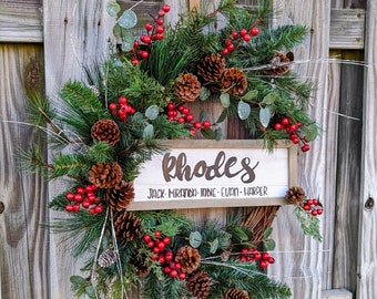 Christmas wreath hand painted custom sign perfect for personalized gift giving. Grapevine covered in pine, berries pinecones. 24”