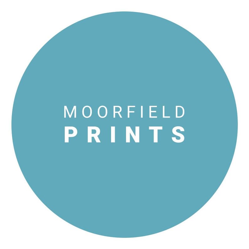 A blue circular logo with the text "MOORFIELD PRINTS" displayed prominently in the center.