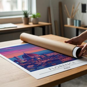 May include: A white ceramic mug with a black handle and the text "But First, Coffee" in a bold, black font. The mug is set against a blurred background, suggesting a cozy setting.