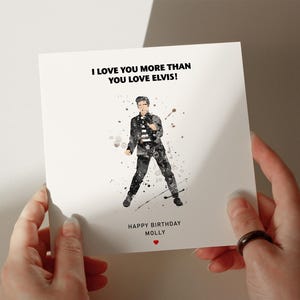 a person holding a card with a picture of a man in a suit
