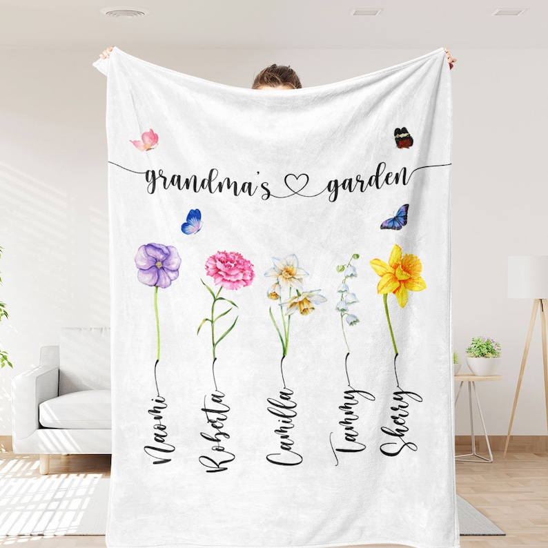 May include: White fleece blanket with the text "grandma's garden" and five watercolour flowers with names underneath: Naomi, Robsetta, Cammilla, Tammy, Sherry.