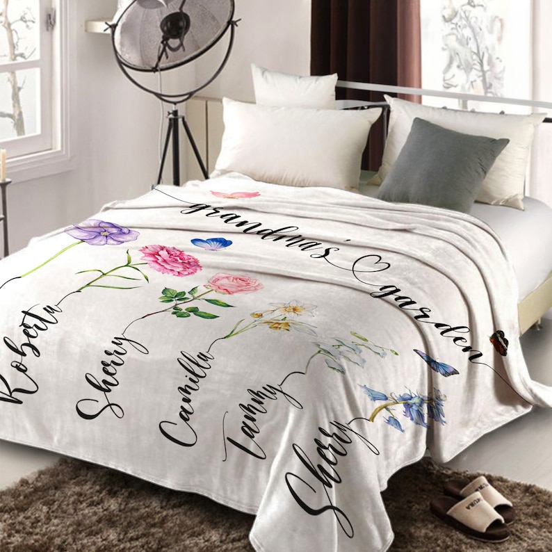 May include: White fleece blanket featuring a floral design and the text "Grandma's Garden". The flowers are labelled with names such as "Roberta", "Sherry", and "Camilla".