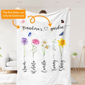 May include: White fleece blanket with the text "grandma's garden" and five flowers with names underneath: Naomi, Robsetta, Cammilla, Tammy, Sherry.