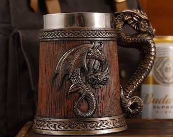 May include: A brown tankard with a wood grain texture and a metallic silver rim. The exterior features a raised relief of a dragon with wings and a tail that forms the handle. The top and bottom edges are decorated with a braided knot pattern.