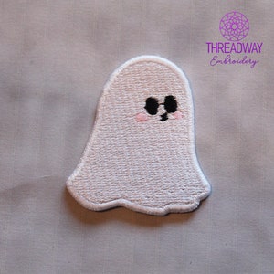May include: White embroidered ghost patch with black eyes and a small pink blush. The patch has a scalloped edge and is from Threadway Embroidery.