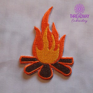 May include: Embroidered patch depicting a campfire. The flames are in shades of orange and yellow, with brown logs at the base. The patch has a white border and the text "THREADWAY Embroidery" in purple.
