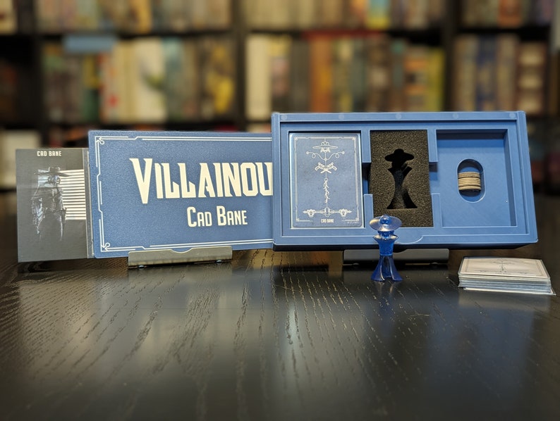 May include: A blue box with a card game called "Villainous: Cad Bane" inside. The box has a black and white illustration of Cad Bane on the front. The game includes a blue plastic figure of Cad Bane.