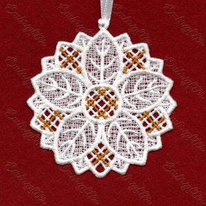 May include: White lace ornament with gold embroidery in the shape of a flower. The ornament has a loop at the top for hanging.
