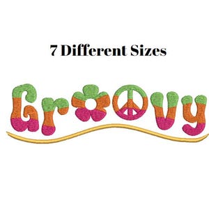 May include: Embroidered design with the word "Groovy" in a retro style. The letters are in green, orange, and pink, with a peace symbol replacing the "O". The text "7 Different Sizes" is above the word, all on a white background.