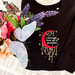 Through Love, All is Possible Embroidered Sarah J. Maas Licensed Unisex organic sweatshirt