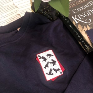 The Crow Club Unisex Organic Sweatshirt Pictured in Navy, Six of Crows Inspired