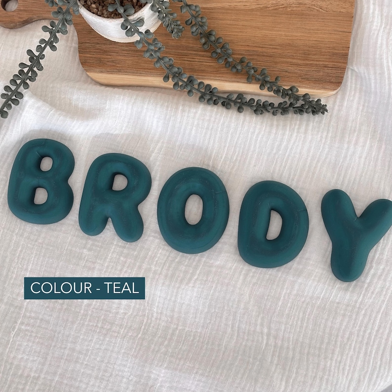 the word "BRODY" spelled out using teal-colored letters on a white background.
