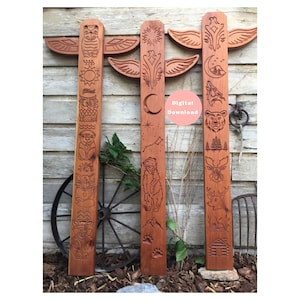 May include: Three wooden totem poles with carved designs of animals, plants, and celestial bodies. The poles are painted in shades of brown and red. The text "Digital Download" is visible on a pink circle.