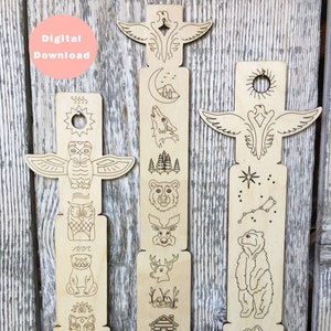 Può includere: Due segnalibri in legno a forma di totem con una varietà di disegni a tema natura, tra cui un orso, un lupo, un gufo, un cervo e una capanna. I segnalibri sono tagliati al laser e pronti per essere dipinti.