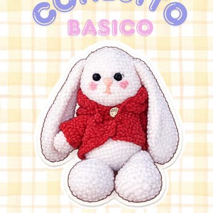 May include: A white amigurumi bunny wearing a red jacket. The bunny has black eyes and pink cheeks. The image includes text that reads "CONEJITO BASICO" and "BASIC AMIGURUMI BUNNY". The background is a yellow plaid pattern.