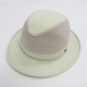 May include: A light sage green fedora hat featuring a solid crown top and a wide, circular brim with stitched detailing. The mid-section of the crown is constructed from a breathable, textured mesh fabric, while the base includes a smooth band.