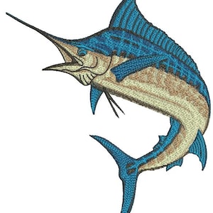 May include: An embroidered patch featuring a marlin fish in a leaping pose. The fish has a vibrant blue dorsal fin and tail, with a textured tan and cream-colored body. The design includes detailed stitching that defines the scales and fins.