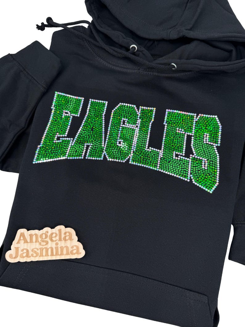 May include: Black hoodie with a green rhinestone design that says "EAGLES".