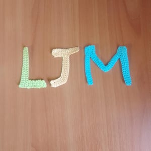 May include: A white ceramic mug with a black handle and the text "But First, Coffee" in a bold, black font. The mug is filled with a dark liquid, likely coffee, and rests on a light-coloured surface.