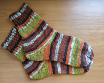 May include: Striped knitted socks in brown, green, orange, white, and black.