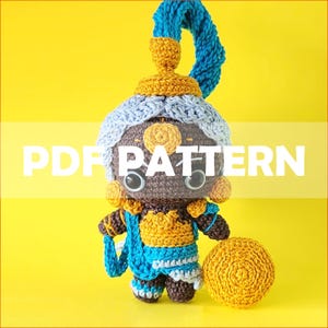 May include: Crochet amigurumi pattern for a genie character with a blue turban, gold accents, and a brown face. The pattern includes instructions for making a small, round, yellow orb.