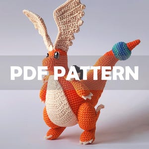 May include: A crocheted orange dragon with cream-colored belly and wings. The dragon has a long tail with a blue and green ball at the end. The text "PDF PATTERN" is overlaid on the image.