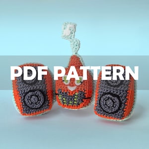 May include: Crocheted toy pattern featuring three colorful, handmade speakers. The speakers are orange, gray, and black, with a smiling, star-shaped character in the center. The text "PDF PATTERN" is displayed across the image.