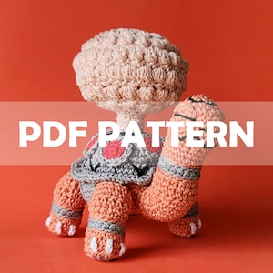 Könnte beinhalten: Häkelanleitung für eine rosa und orangefarbene Amigurumi-Schildkröte mit einem pilzförmigen Kopf. Das Muster ist als PDF-Download erhältlich.  PDF PATTERN.