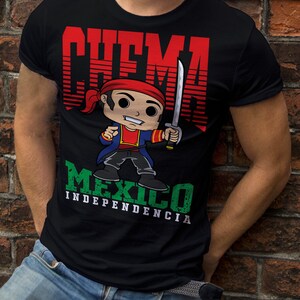 May include: Black t-shirt with a cartoon illustration of a man wearing a red bandana and holding a sword. The text "CHEMA MEXICO INDEPENDENCIA" is printed on the shirt.