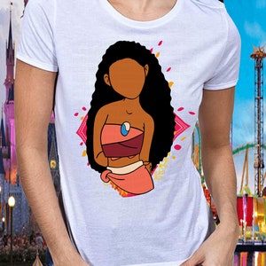 May include: White t-shirt with a cartoon illustration of a brown-skinned woman with long black hair wearing a pink and red outfit. The woman is standing in front of a pink and yellow floral design.
