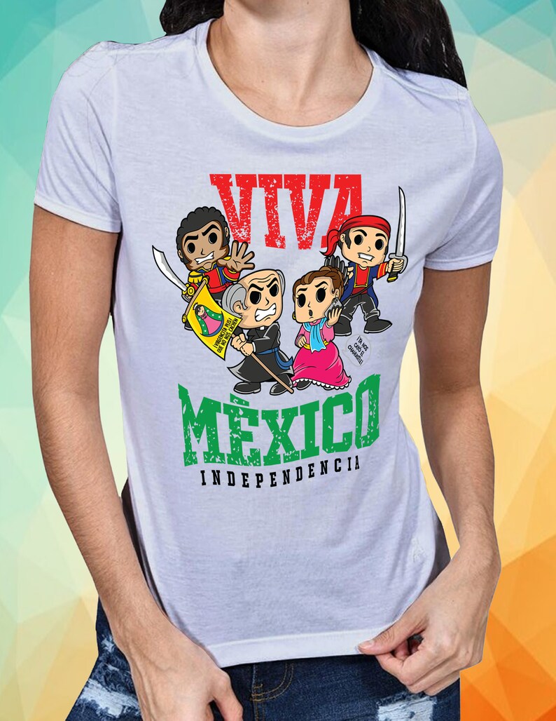 May include: White t-shirt with a green, white, and red graphic design. The graphic features cartoon characters and the text "Viva Mexico Independencia".