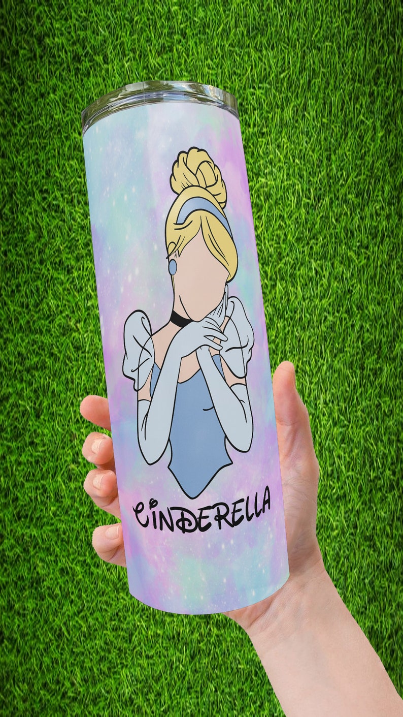 May include: A stainless steel tumbler with a galaxy-like background featuring a cartoon image of Cinderella in a blue dress with the word "Cinderella" printed below her.