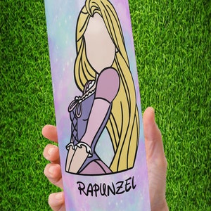 May include: A stainless steel tumbler with a galaxy-themed design featuring a cartoon image of Rapunzel from the Disney movie Tangled. The tumbler has a pink, blue, and purple galaxy background with stars and glitter. The text "Rapunzel" is printed on the bottom of the tumbler.