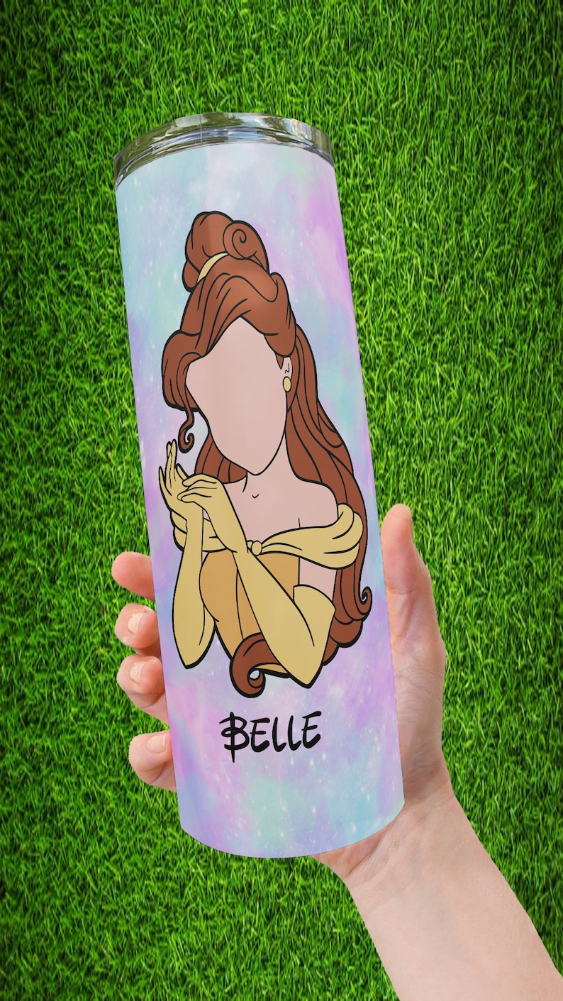 May include: A stainless steel tumbler with a colorful galaxy design featuring Belle from Beauty and the Beast. The tumbler has the word "Belle" written in gold script.