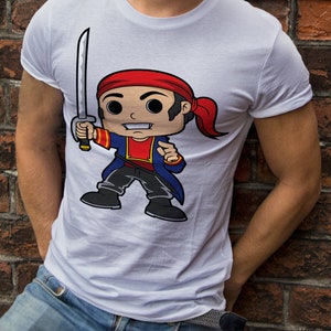 May include: White t-shirt with a cartoon illustration of a pirate holding a sword. The pirate is wearing a red bandana, blue jacket, and black pants.