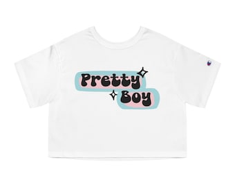 May include: White cropped t-shirt with a pink and blue graphic that says "Pretty Boy" in black letters with two small stars.