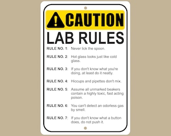 May include: A white sign with a yellow caution triangle and the text "CAUTION LAB RULES" in black. The sign lists seven rules for lab safety, including "Never lick the spoon" and "Hiccups and pipettes don't mix."